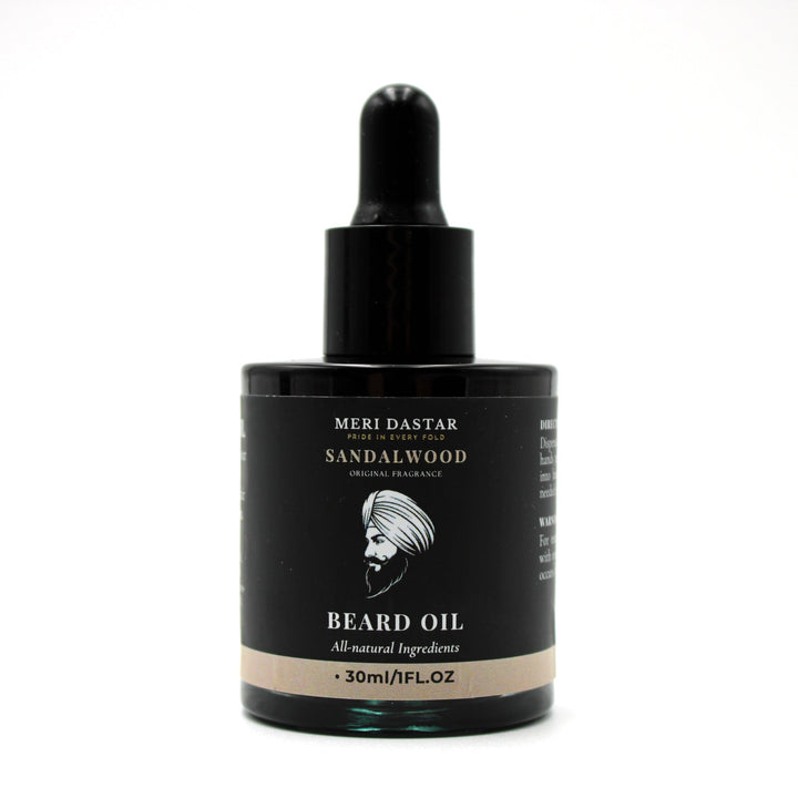 Beard oil dropper bottle with black label on a white background