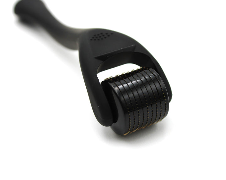Black derma roller on a white background