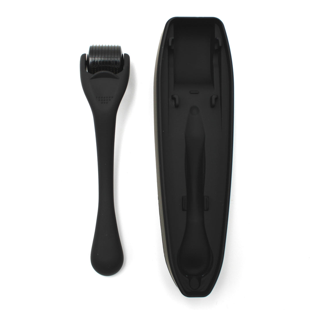 Black derma roller tool with roller head and handle on a white background