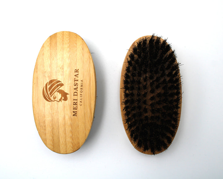 Wooden brush with bristles and Meriastar logo on a white background