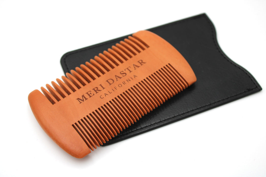 Orange comb with black case on a white background