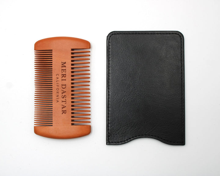 Brown comb and black leather case on a white background