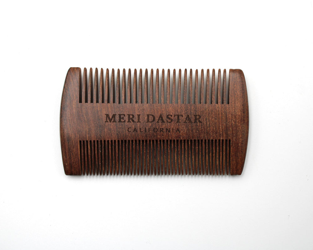 Wooden comb with 'MERI DASTAR' branding on a white background
