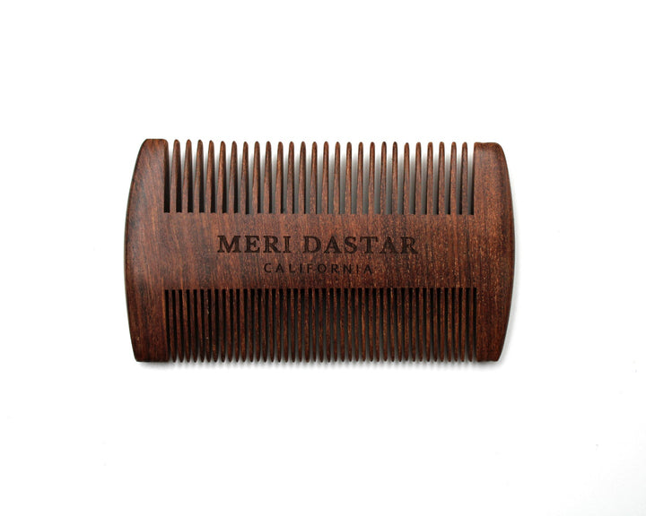 Wooden comb with 'MERI DASTAR' branding on a white background